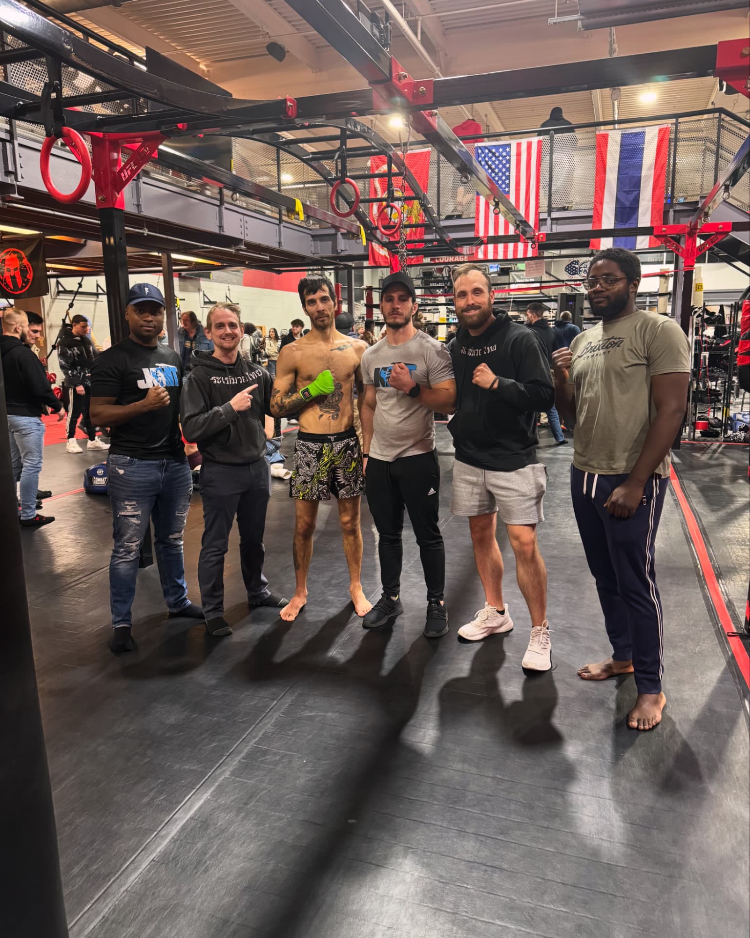Team photo at the gym with fighters and coach
