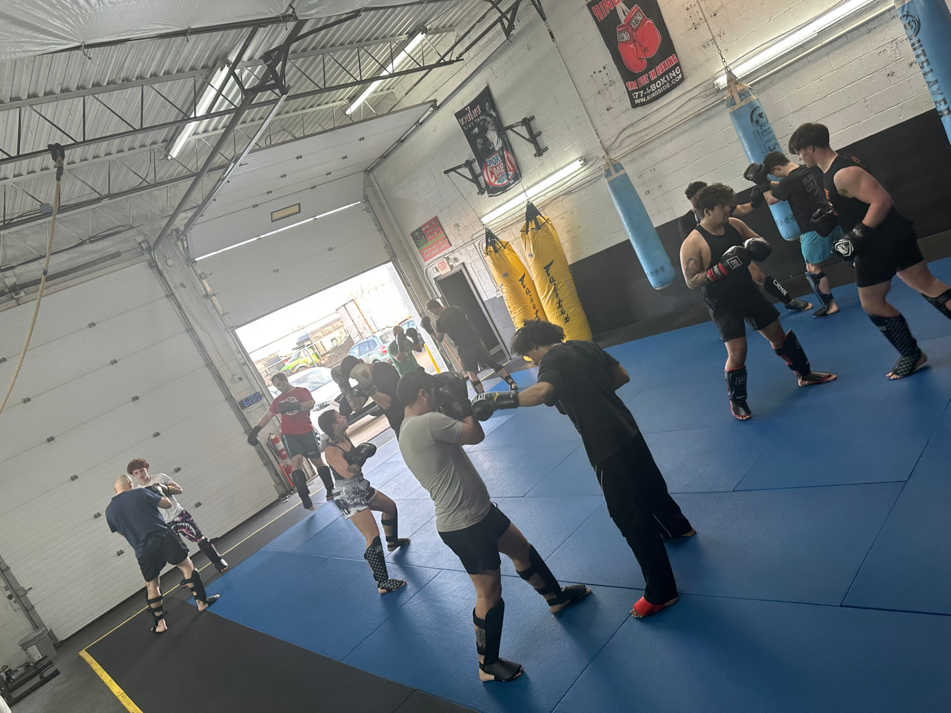 Sparring rounds across the gym floor